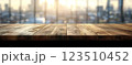 Wooden Table Surface with Sunset Blurry Cityscape and Nature Background, Warm Tones, and Soft Focus Lights Creating a Cozy Atmosphere for Relaxation 123510452