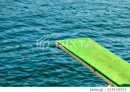 View of diving board. Springboard to dive at water. View of diving board. Springboard to dive at water. 123510531