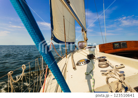 Yachting on sail boat during sunny weather 123510641