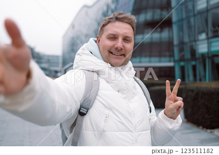 Happy young man taking selfie pic with smart mobile phone device outside Happy young man taking selfie pic with smart mobile phone device outside 123511182