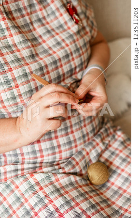 Close-up view of hands of an older woman crocheting Close-up view of hands of an older woman crocheting 123511203