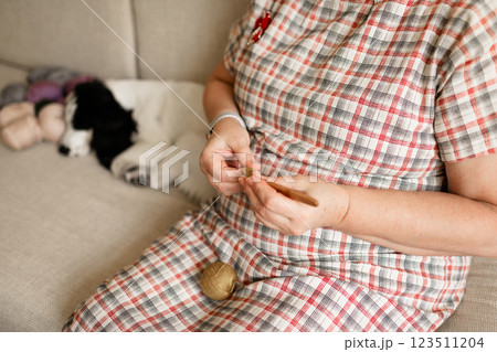 Close-up view of hands of an older woman crocheting Close-up view of hands of an older woman crocheting 123511204
