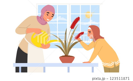 A mother and daughter enjoy quality time together indoors, where they water a vibrant plant and admire its colorful flowers in a cozy, bright room A mother and daughter enjoy quality time together indoors, where they water a vibrant plant and admire its colorful flowers in a cozy, bright room 123511871