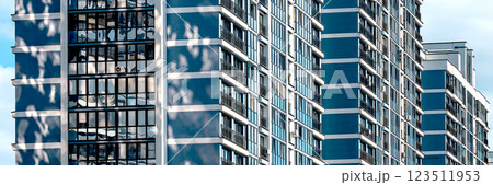 Modern high-rise condominium in downtown city. Concrete facade with large windows offering views of Modern high-rise condominium in downtown city. Concrete facade with large windows offering views of 123511953