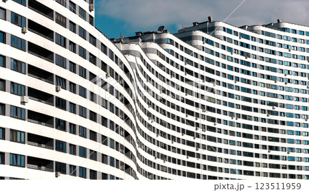 Modern high-rise condominium with a wavy, curved shape in a metropolitan city. Unique architecture, Modern high-rise condominium with a wavy, curved shape in a metropolitan city. Unique architecture, 123511959