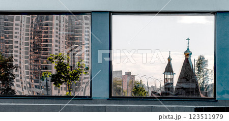 Reflection of domes and tree on glass window, contrasting with urban architecture. Modern Reflection of domes and tree on glass window, contrasting with urban architecture. Modern 123511979