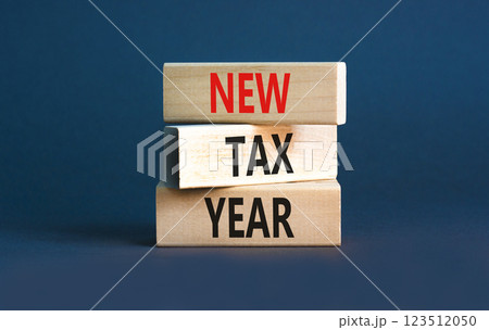 New tax year symbol. Concept words New tax year on beautiful wooden blocks. Beautiful grey table grey background. Business new tax year concept. Copy space. 123512050