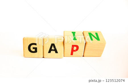 Gain or gap symbol. Concept words Gain Gap on wooden block. Beautiful white table white background. Business gain or gap concept. Copy space. 123512074
