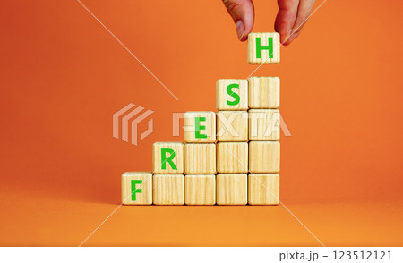 Fresh symbol. Concept word Fresh on beautiful wooden blocks. Beautiful orange table orange background. Businessman hand. Business lifestyle fresh concept. Copy space. 123512121