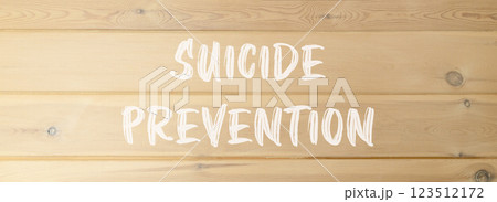 Suicide prevention symbol. Concept words Suicide prevention on beautiful wooden wall. Beautiful wooden wall background. Psychological and suicide prevention concept. Copy space. 123512172