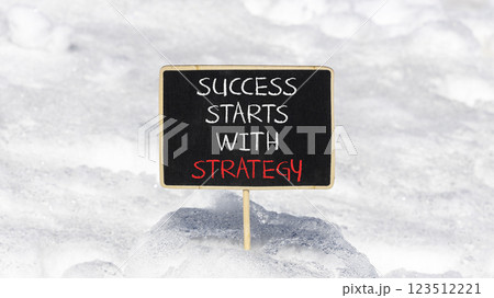 Success starts with strategy symbol. Concept words Success starts with strategy on beautiful blackboard. Beautiful snow background. Business and success starts with strategy concept. Copy space. 123512221