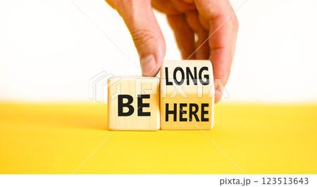 Belonging and belong symbol. Concept words Be here Belong on beautiful wooden block. Beautiful white background Businessman hand. Business motivational belonging and belong concept. Copy space. 123513643