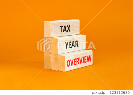 Tax year overview symbol. Concept words Tax year overview on beautiful wooden blocks. Beautiful orange table orange background. Business tax year overview concept. Copy space. 123513680