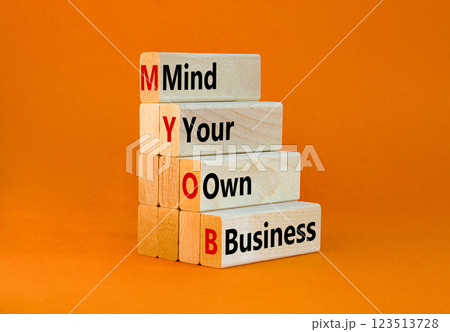 MYOB mind your own business symbol. Concept word MYOB Mind Your Own Business on beautiful wooden blocks. Beautiful orange background. Business MYOB mind your own business concept. Copy space. 123513728