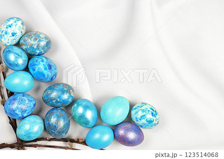 Blue marble easter eggs painted with blue moon matcha on grey concrete background with sakura branches, easter home cooking ideas, easter celebration concept 123514068