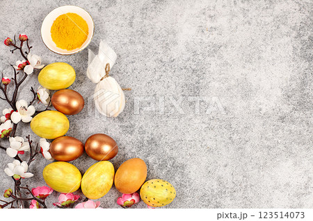 Easter celebration concept. Easter egg dyeing recipe with natural dyes, Easter homemade cooking ideas. Marbled eggs dyed with golden turmeric, Gray concrete background. Easter celebration concept. Easter egg dyeing recipe with natural dyes, Easter homemade cooking ideas. Marbled eggs dyed with golden turmeric, Gray concrete background. 123514073