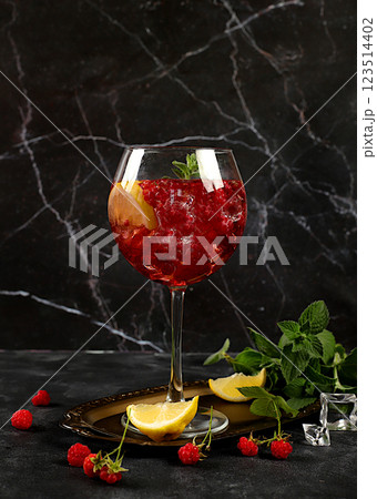 Royal lemonade cocktail with tequila, gin, rum, vodka, liqueur, lime, ice and fresh raspberries, bar and party concept, advertising card for restaurant and cafe, black background, . 123514402