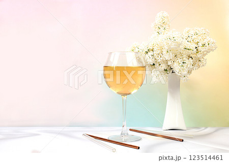 Festive alcoholic cocktail, white wine in a glass on a bright background with a bouquet of white lilacs, summer bar concept, alcoholic drinks at a party, restaurant and cafe advertising, selective 123514461