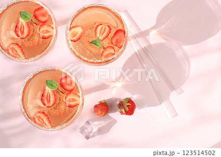 Modern still life with pink martini, flat lay, alcoholic cocktail, strawberry on elegant modern background with long shadows, minimal concept for bar and holiday party, cafe, advertising banner, 123514502