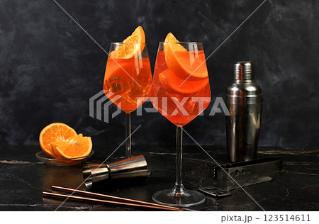 Festive alcoholic cocktail Aperol spritz in glasses on a dark background, concept for bar and New Year's Eve, alcoholic drinks at a party, advertising for a restaurant, selective focus 123514611