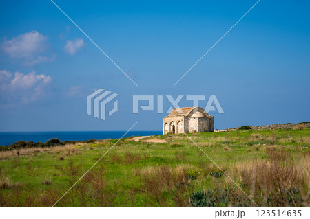 An old Orthodox church in ruins stands by the sea on the northern coast of Cyprus. The image reflects history, faith, and the passage of time in a coastal Mediterranean setting. An old Orthodox church in ruins stands by the sea on the northern coast of Cyprus. The image reflects history, faith, and the passage of time in a coastal Mediterranean setting. 123514635