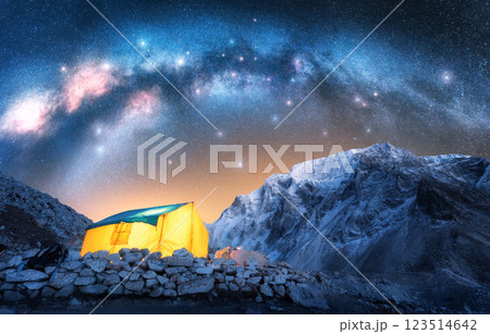 Milky Way, glowing yellow tent in snowy mountains at starry night Milky Way, glowing yellow tent in snowy mountains at starry night 123514642