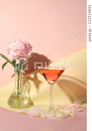 Modern still life with pink martini, alcoholic cocktail and peony flowers on elegant modern background, minimal concept for bar and holiday party, cafe, advertising banner, selective focus, space for Modern still life with pink martini, alcoholic cocktail and peony flowers on elegant modern background, minimal concept for bar and holiday party, cafe, advertising banner, selective focus, space for 123514691