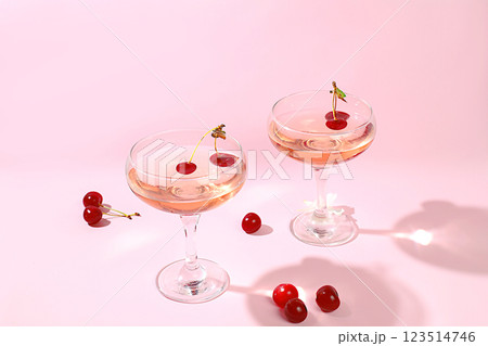 Modern still life with rose wine, alcoholic cocktail and cherry berries on elegant modern background, minimal concept for bar and holiday party, cafe, advertising banner, selective focus, space for 123514746