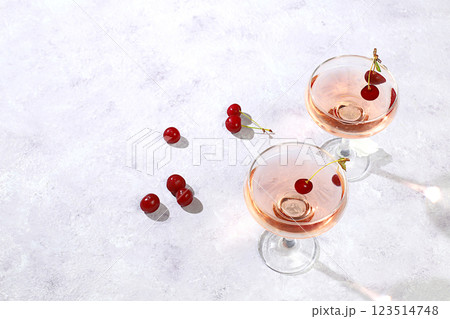 Modern still life with rose wine, alcoholic cocktail and cherry berries on elegant modern background, minimal concept for bar and holiday party, cafe, advertising banner, selective focus, space for 123514748