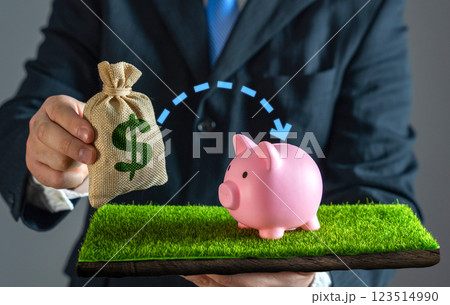 A businessman puts money into savings. Financial security and smart money management. Funds into a savings account, building wealth, securing the future, and practicing responsible financial planning. 123514990