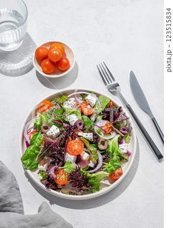 Vegetable salad (Greek salad) with cherry tomatoes, feta cheese, lettuce, olives and red onion  123515834