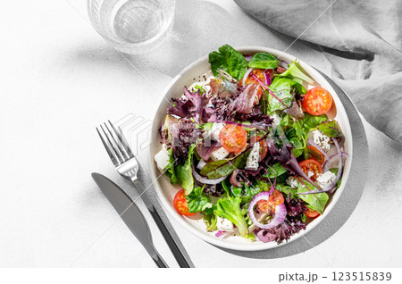 Vegetable salad (Greek salad) with cherry tomatoes, feta cheese, lettuce, olives and red onion Vegetable salad (Greek salad) with cherry tomatoes, feta cheese, lettuce, olives and red onion 123515839