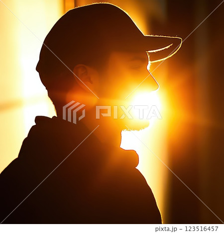 Silhouette of a person against a bright sunset 123516457