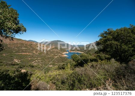 Expansive mountainous landscape with serene lake under clear blue sky, La Concepcion reservoir in Expansive mountainous landscape with serene lake under clear blue sky, La Concepcion reservoir in 123517376