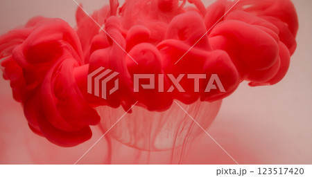 Paint cloud. Flow ink. Defocused red color smoke texture fluid splash over glass bubble on abstract art light background. 123517420