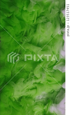 Wave paint art. Water ink surface. Defocused green white color haze cloud smoke liquid fume vapor flow on abstract light background. 123517451