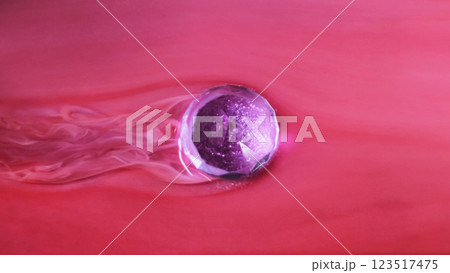 Floating christmas ball. Wet paint. Defocused purple red color glitter glow globe smooth wave ink texture on abstract art background. Floating christmas ball. Wet paint. Defocused purple red color glitter glow globe smooth wave ink texture on abstract art background. 123517475