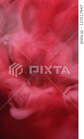 Mystical paint. Red haze. Foggy colored blur puff spray mist surface. Bright ink smoky dissolves in water mixing swirl abstract background. 123517647