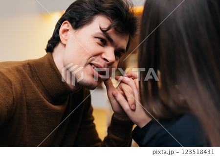 Intimate conversation between a young couple in a cozy cafe setting Intimate conversation between a young couple in a cozy cafe setting 123518431