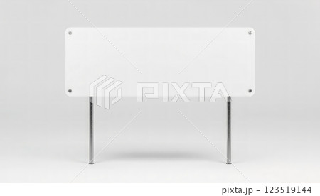 A blank white sign on metal legs stands ready for messages, ideal for advertising, promotions, or events, offering a versatile presentation option. 123519144