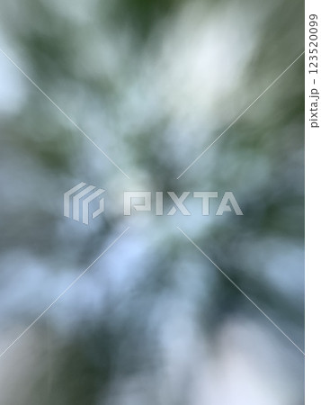 Bright blue abstract sky with green leaves in wind with blur display 123520099