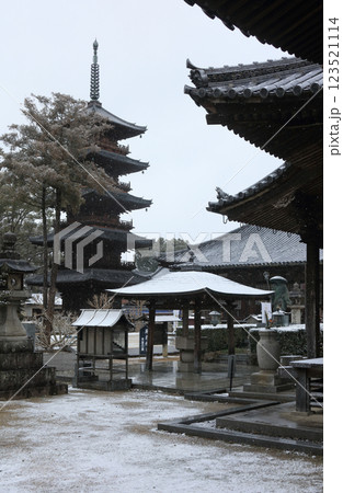 雪の四国霊場第70番札所「本山寺」大門脇から大師堂、本堂、五重塔を見る 123521114