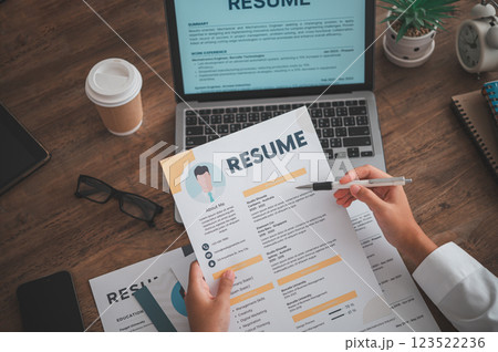 People are reviewing job applications before filling out their resume on the job application form in order to apply for a job at a company. People are reviewing job applications before filling out their resume on the job application form in order to apply for a job at a company. 123522236