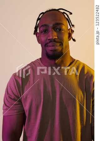 A charismatic and stylish African American man commands attention against a vibrant yellow gel background, showcasing his confident and contemporary fashion sense, radiating charm and sophistication A charismatic and stylish African American man commands attention against a vibrant yellow gel background, showcasing his confident and contemporary fashion sense, radiating charm and sophistication 123522482