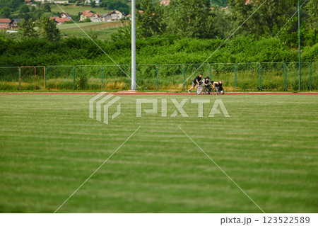 A cameraman filming the participants of the Paralympic race on the marathon course 123522589