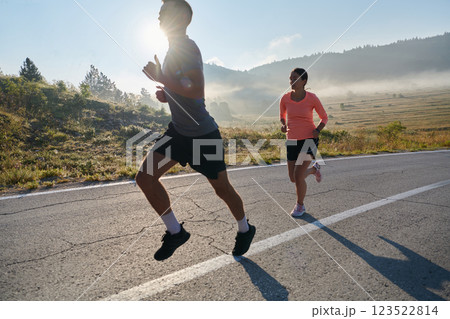 Energized by the beauty of nature, a couple powers through their morning run, their bodies and spirits invigorated. 123522814