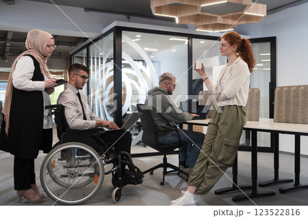 Young group of business people brainstorming together in a startup space, discussing business projects, investments, and solving challenges. 123522816