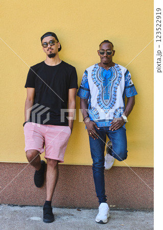 Sudanese Tradition Meets Modern Youth: African American Teen in Vibrant Traditional Attire Against a Yellow Backdrop 123522919