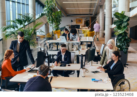 In a modern startup office, a diverse group of young professionals collaboratively tackles various business problems and challenges, surrounded by their engaged colleagues, fostering innovation and 123523408