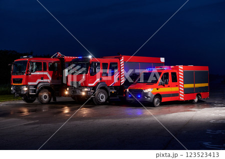 A pair of highly modern and quality fire trucks illuminate the night with their rotating lights, symbolizing the cutting-edge technology and preparedness of the firefighting fleet, ready to respond to A pair of highly modern and quality fire trucks illuminate the night with their rotating lights, symbolizing the cutting-edge technology and preparedness of the firefighting fleet, ready to respond to 123523413